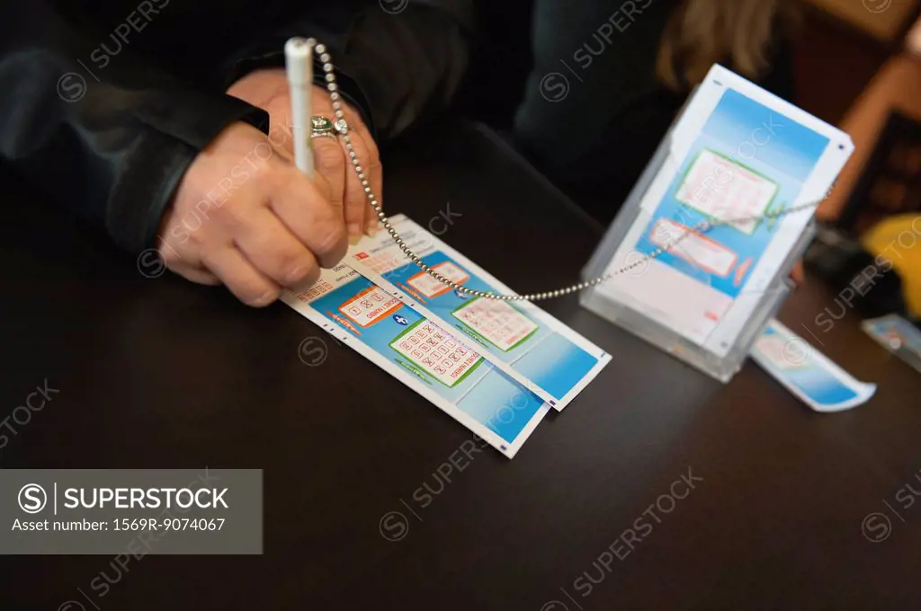 Hands of woman filling out lottery tockets
