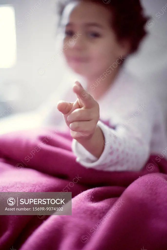 Little girl pointing at camera