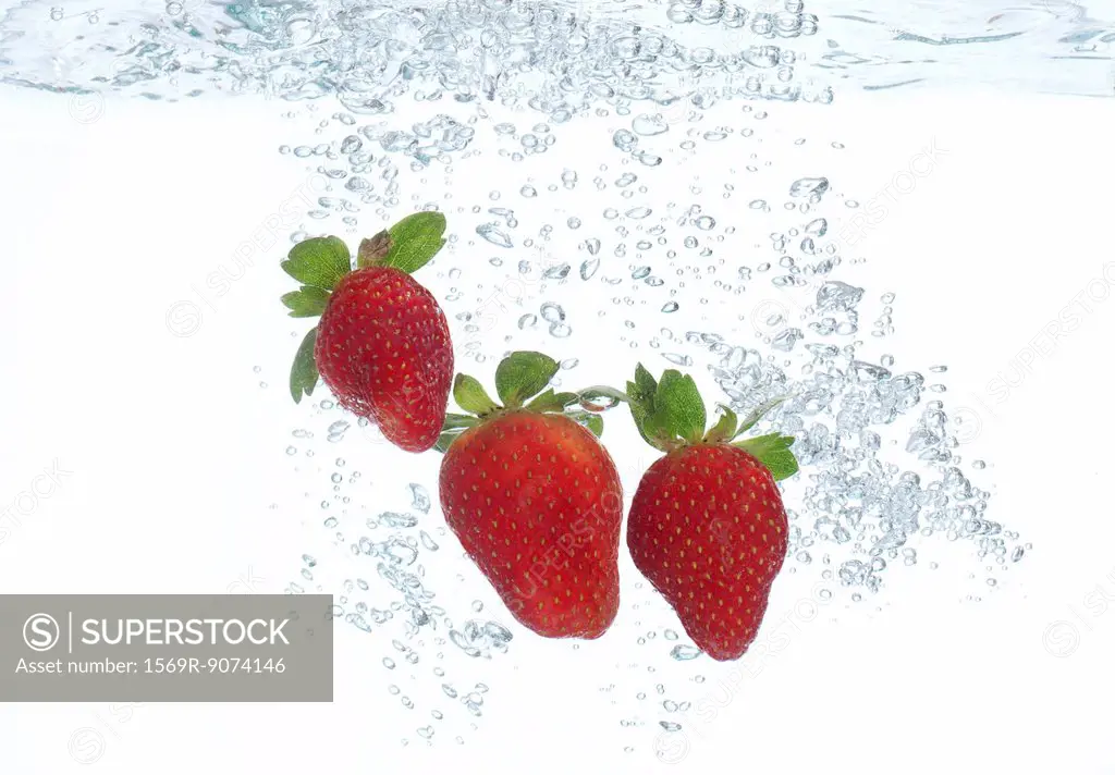 Strawberries submerged in water