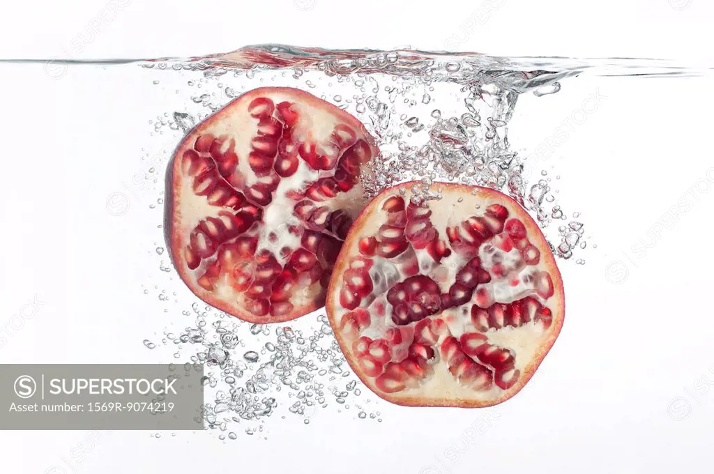 Pomegranate halves submerged in water