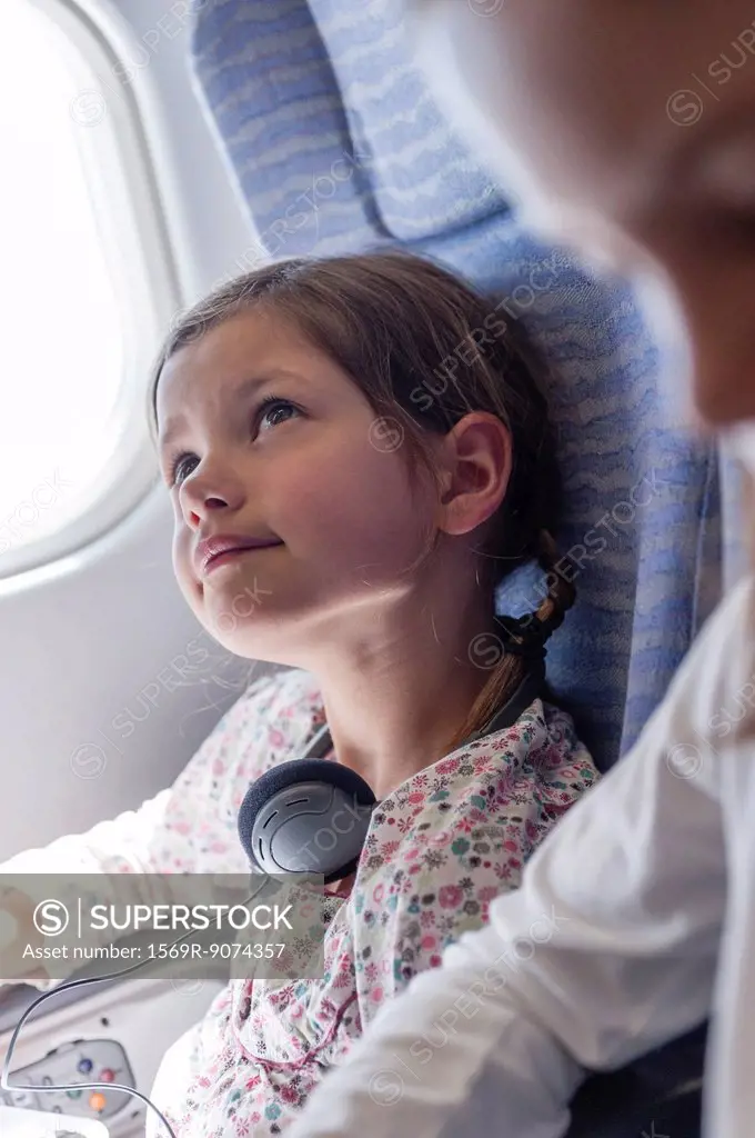 Girl daydreaming on airplane