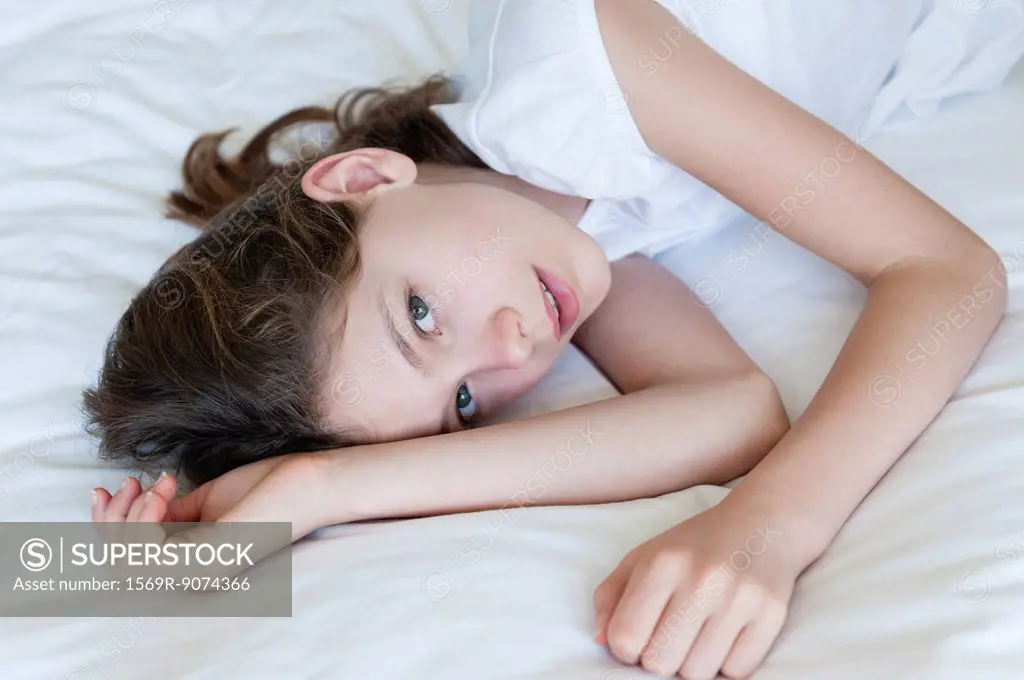 Girl lying on bed, portrait