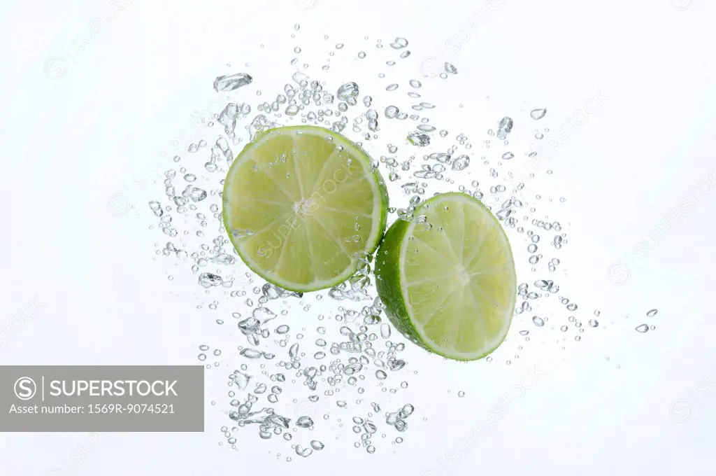 Lime halves submerged in sparkling water