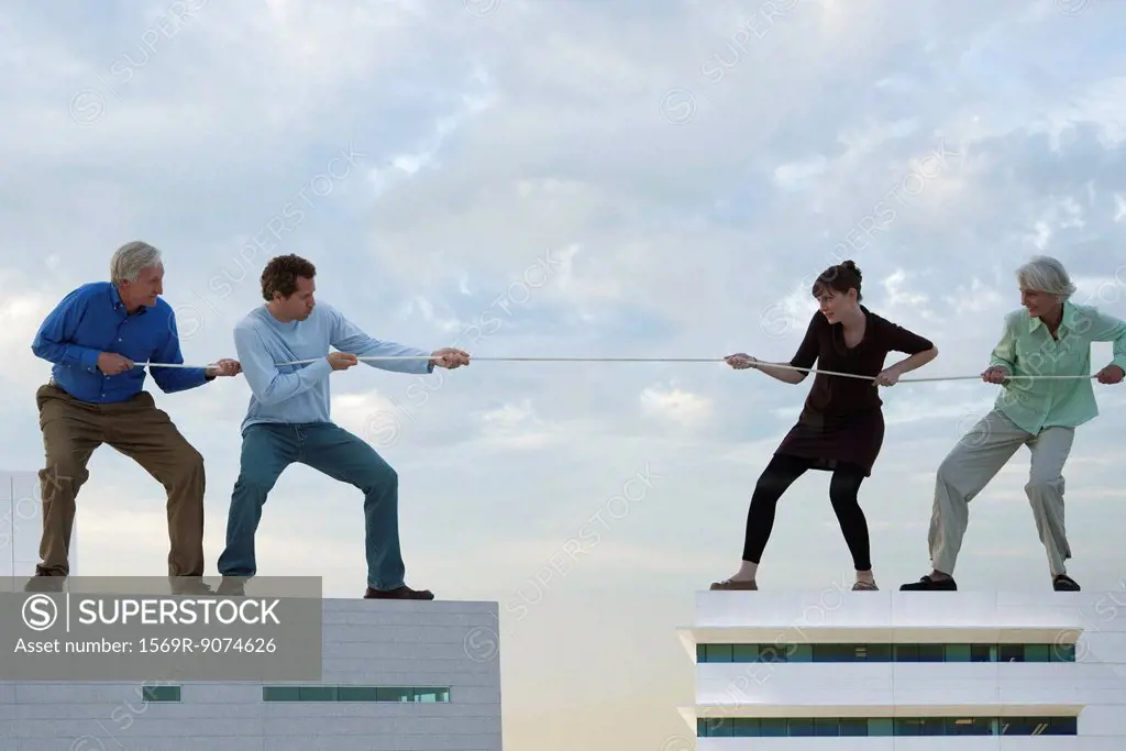 Oversized men and woman standing on rooftops, playing tug_of_war