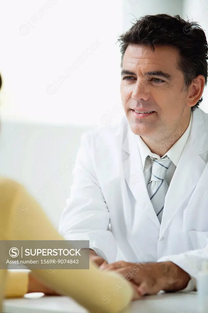 Doctor listening attentively to patient during consultation