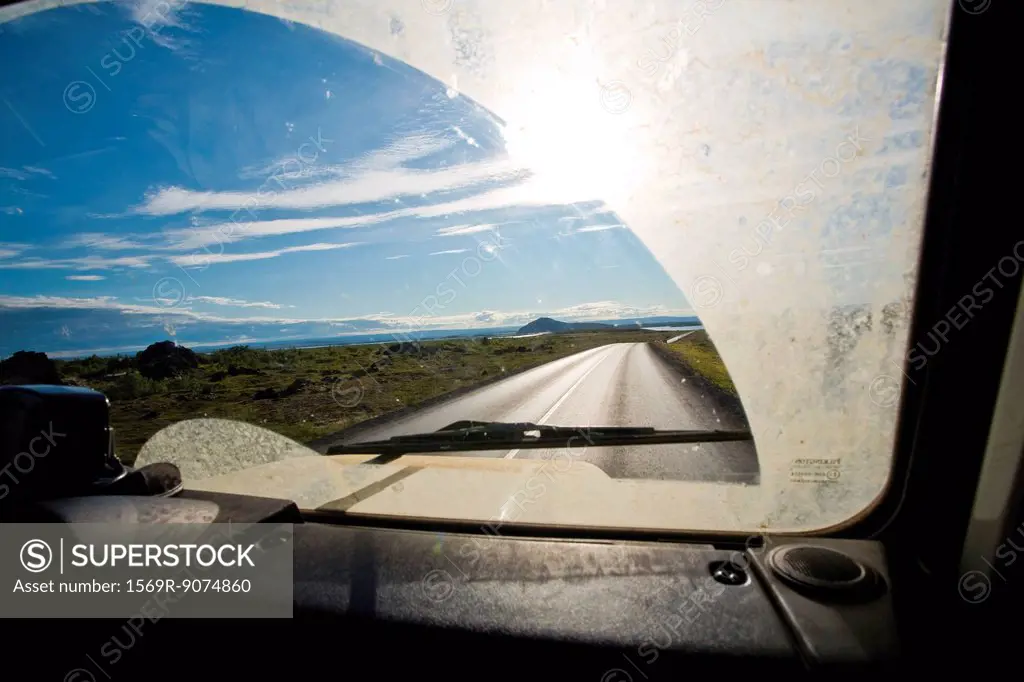 Country road viewed through car windshield