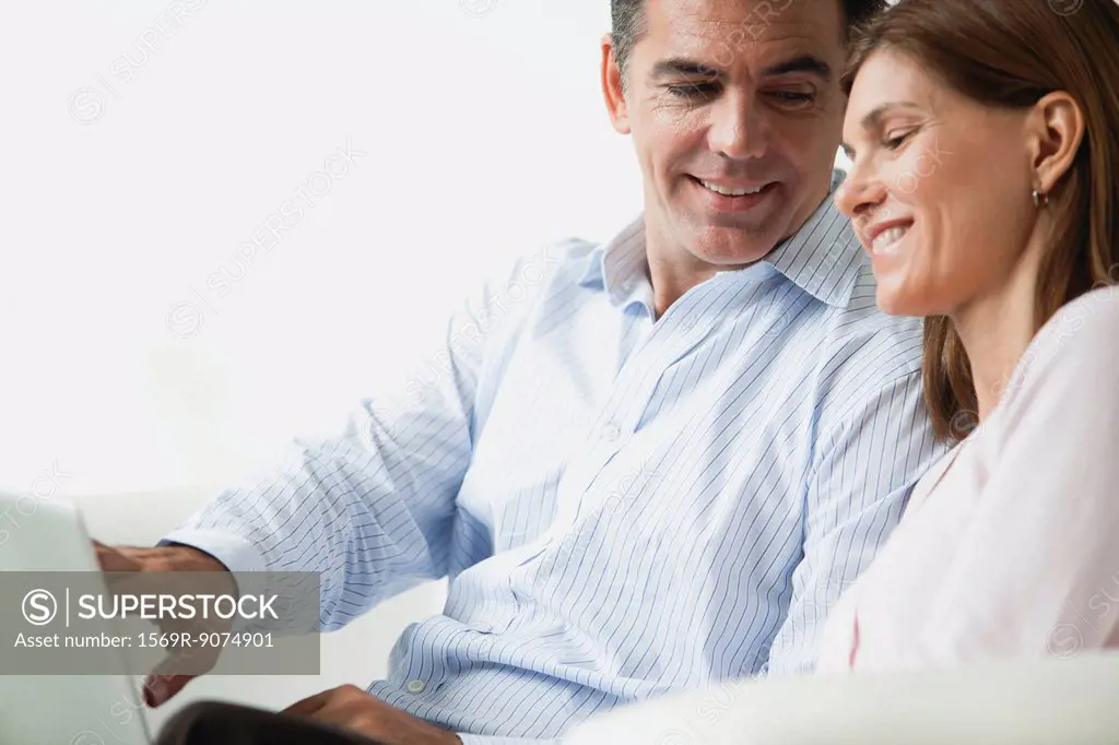 Couple looking at laptop computer together