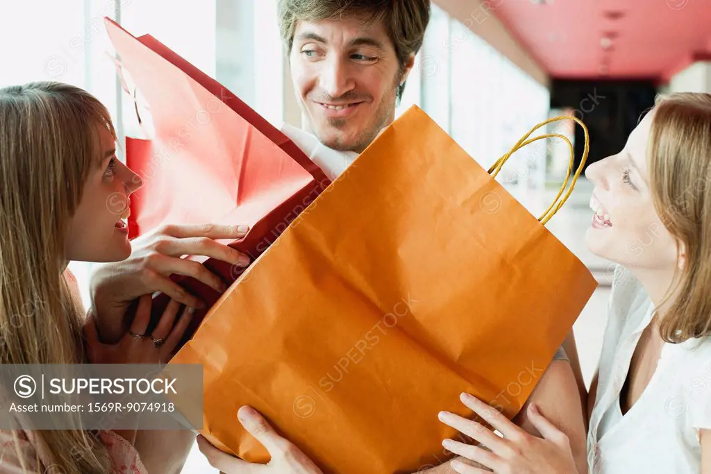 Man holding shopping bags for friends