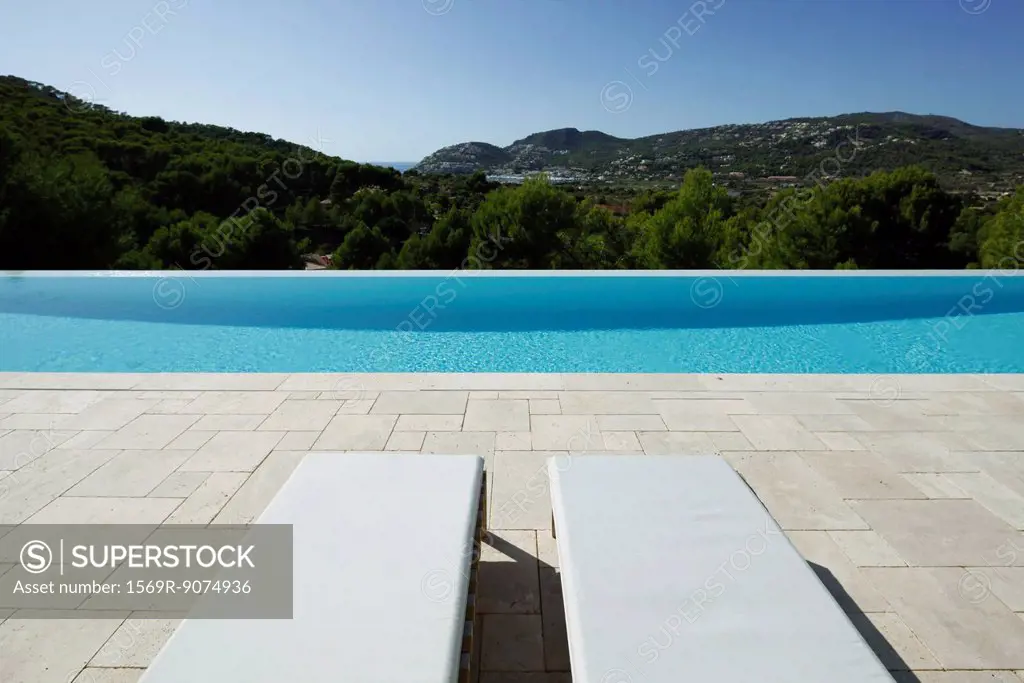 Lounge chairs beside swimming pool