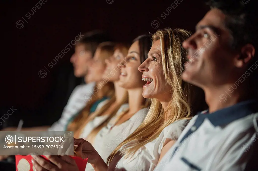 Woman laughing in movie theater