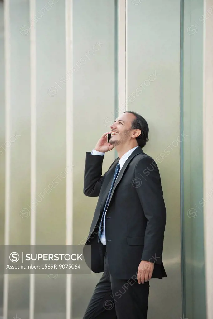 Business executive using cell phone outdoors