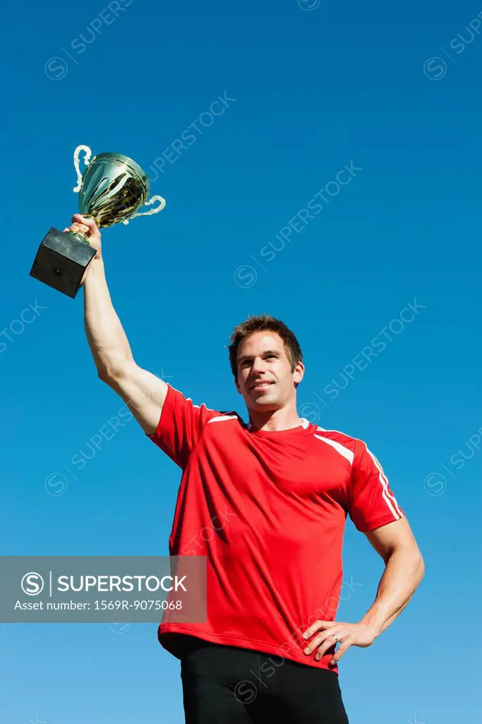 Athlete holding up trophy