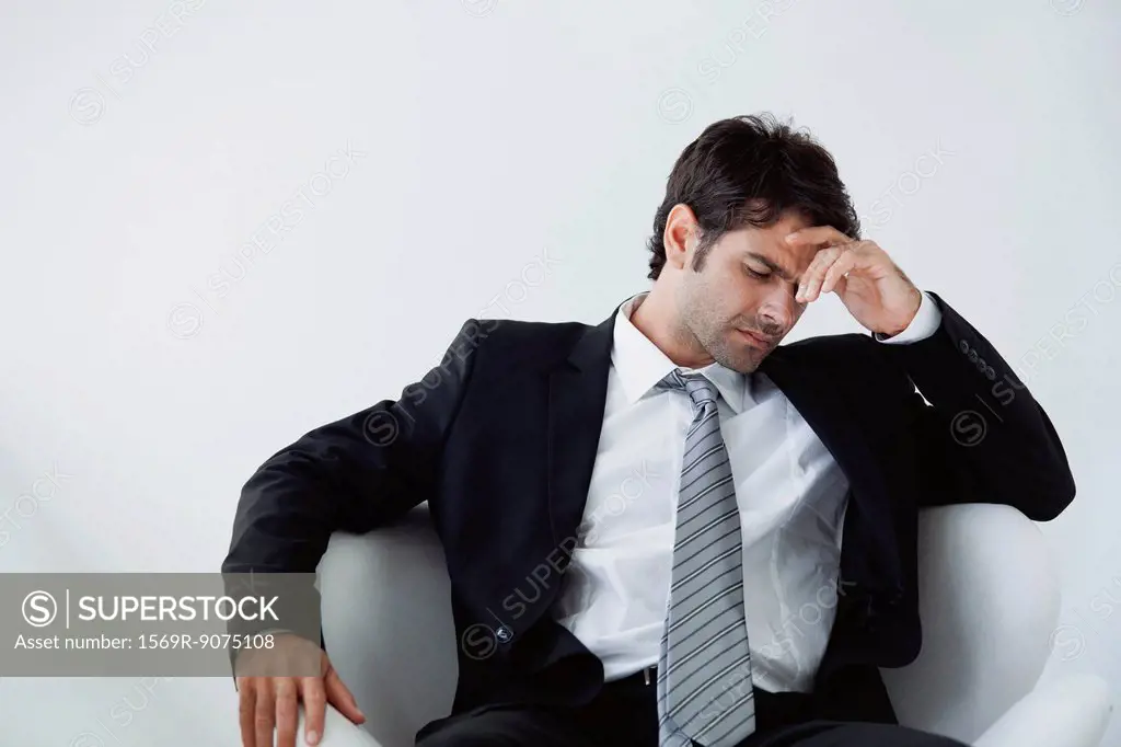 Businessman holding head in disappointment