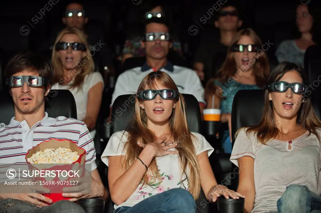 Audience wearing 3_D glasses in movie theater