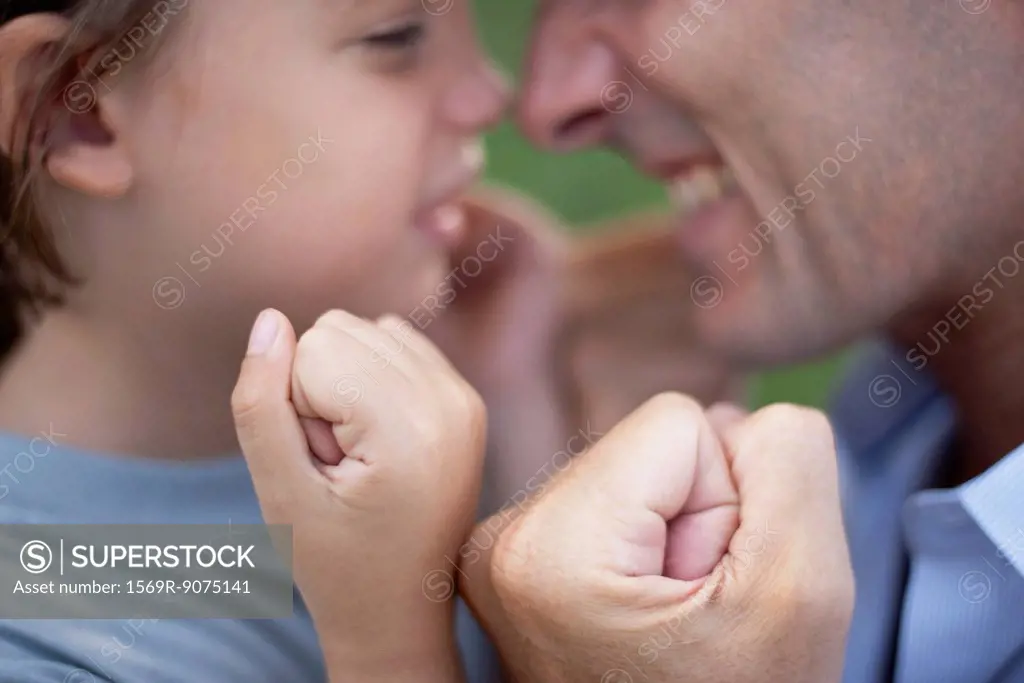 Father and son with fists clenched