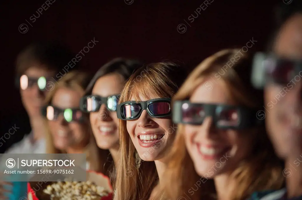 Audience wearing 3_D glasses in movie theater