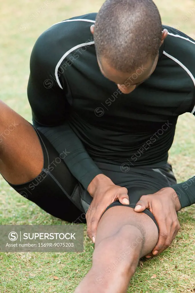 Man with cramp in thigh