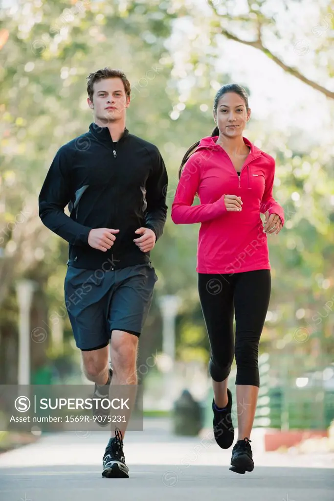 Young couple jogging side by side