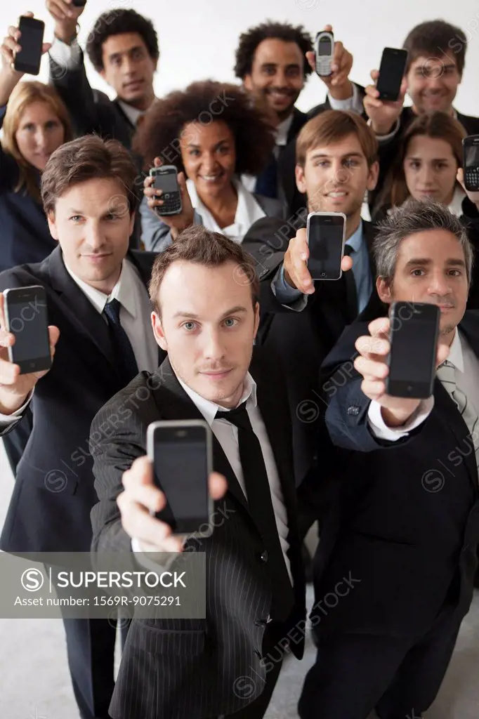 Business professionals holding aloft their cell phones
