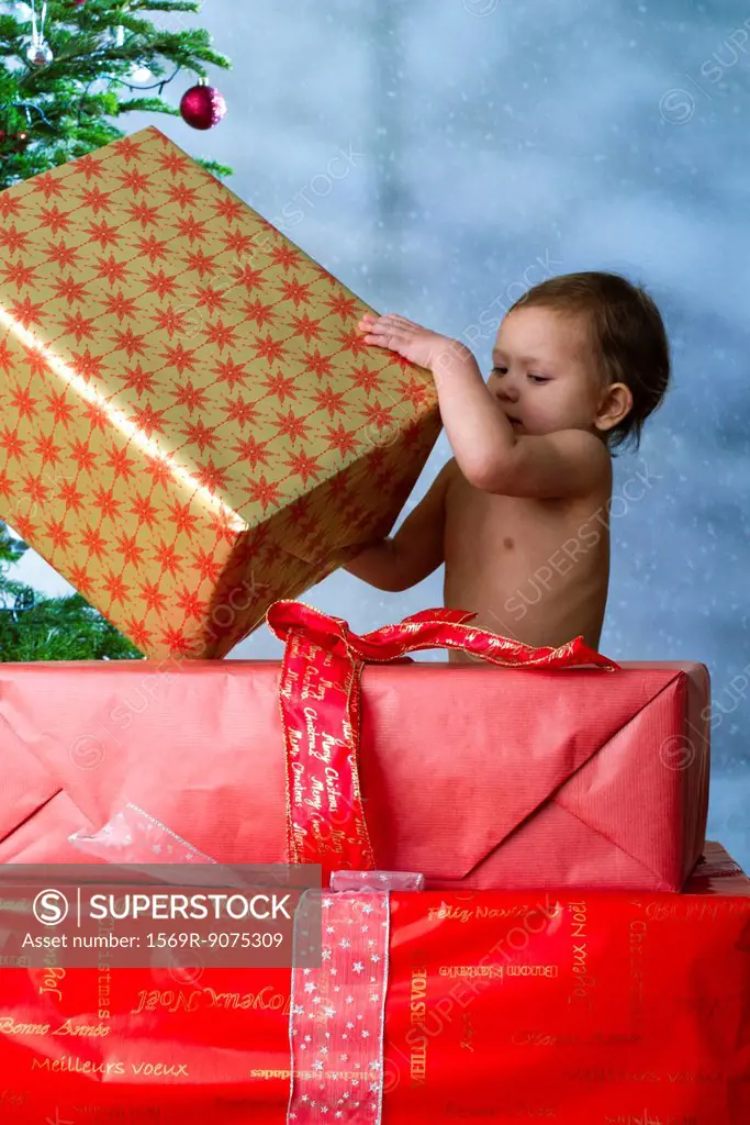 Baby girl opening Christmas presents