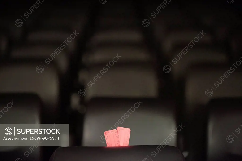 Movie tickets and empty seats in movie theater