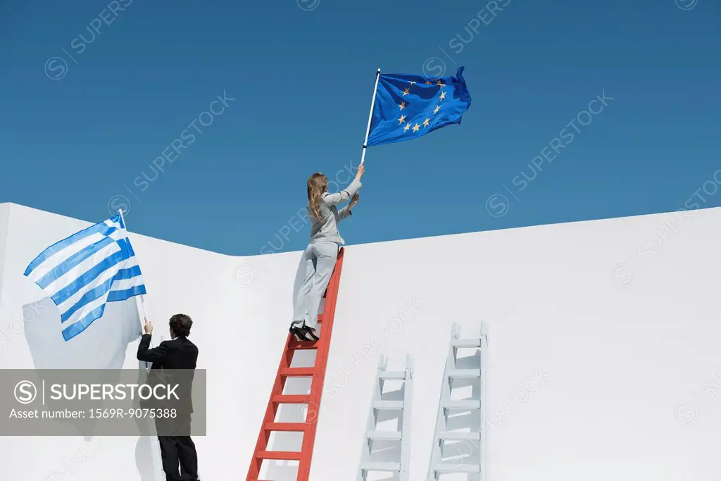 Executives climbing ladders, holding European Union flag and Greek flag to symbolize economic crisis