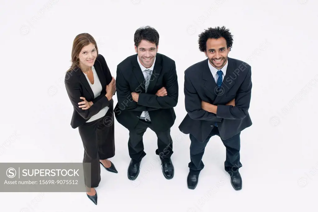 Executives standing together with arms folded, portrait