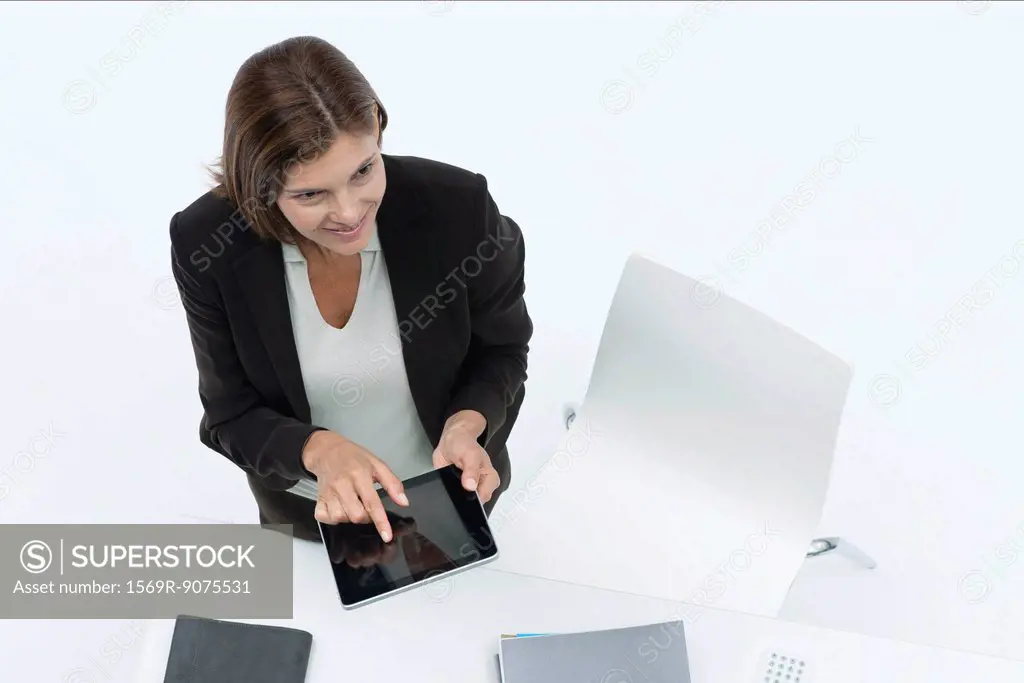 Businesswoman using digital tablet, high angle view