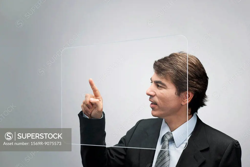 Businessman using large transparent touch screen