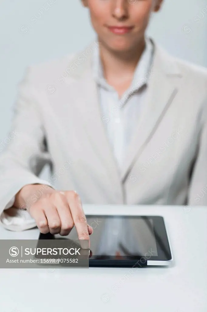 Businesswoman using touch screen on digital tablet