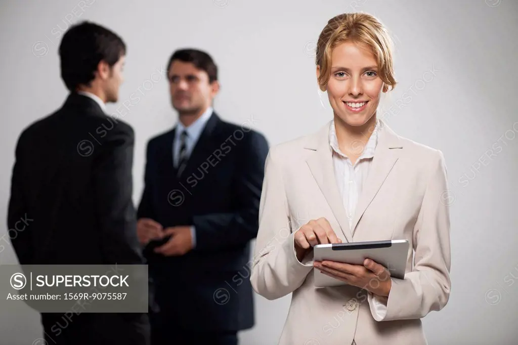Young businesswoman using digital tablet, portrait