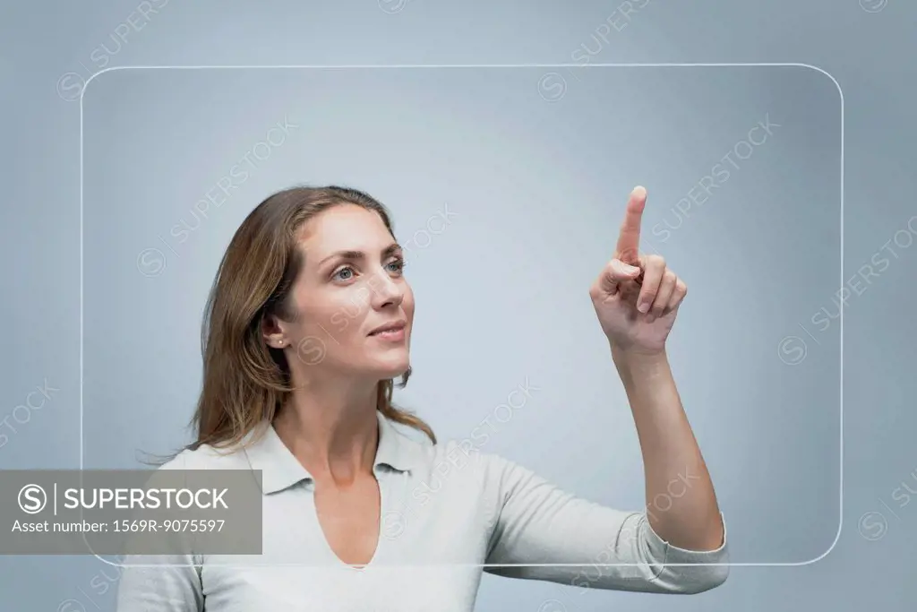 Woman using large transparent touch screen