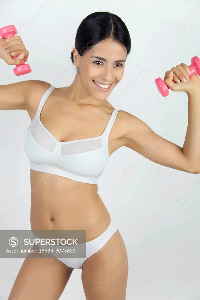 Woman in underwear lifting dumbbells