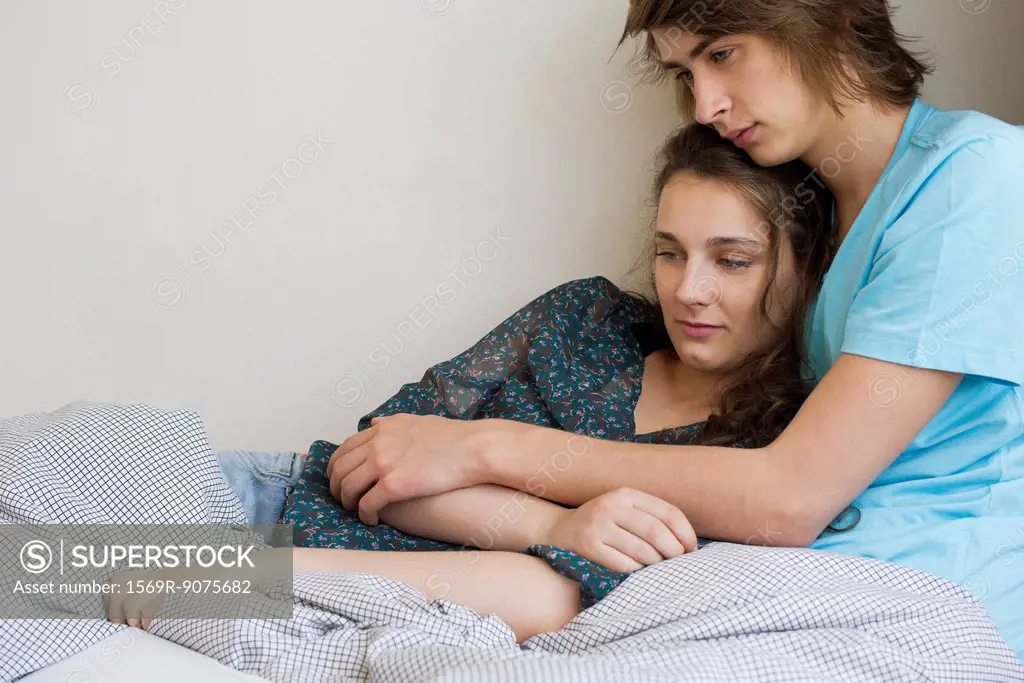 Young couple relaxing together under blanket