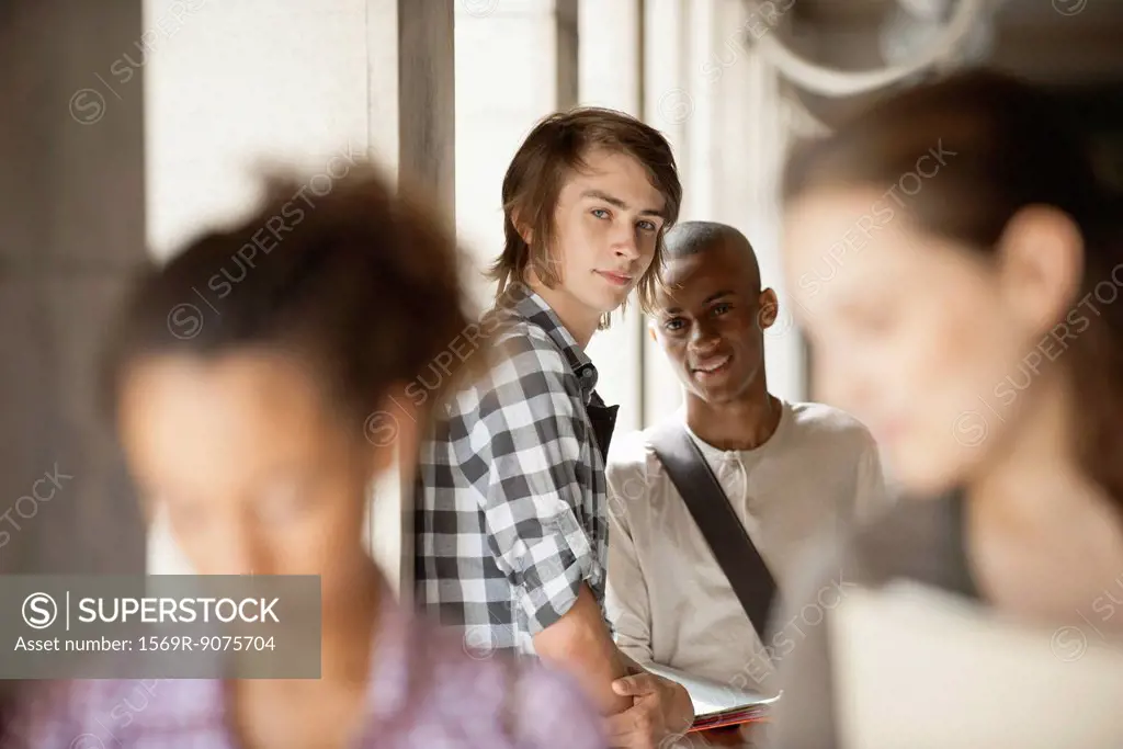 Young man with friend, focus on one person
