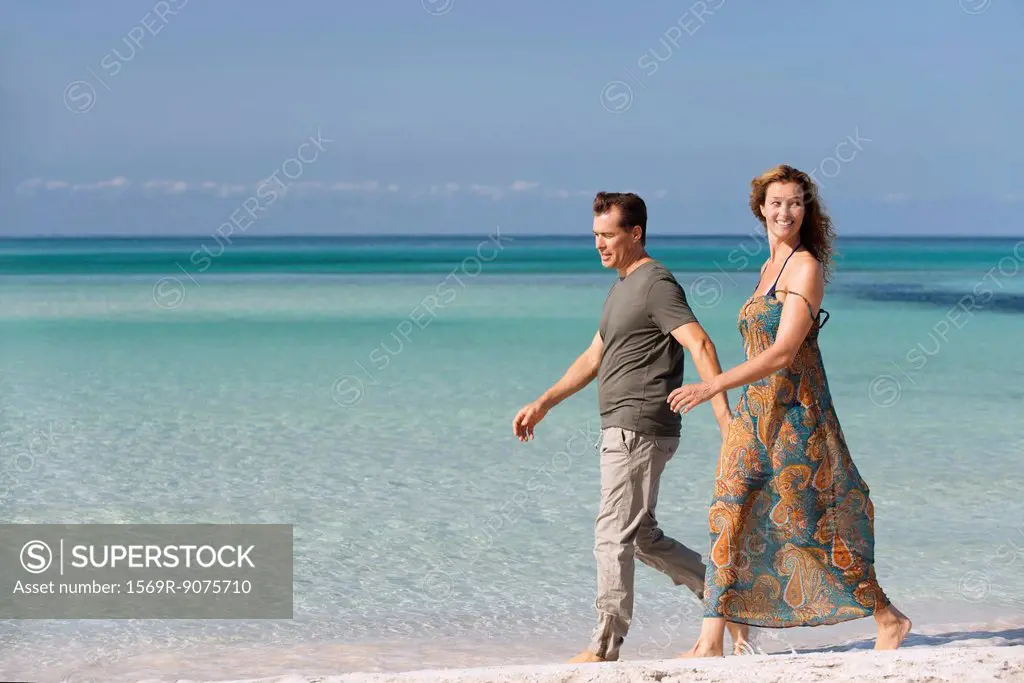 Couple walking leisurely on beach