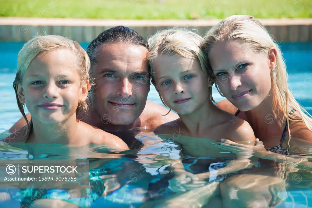 Family together in pool, portrait