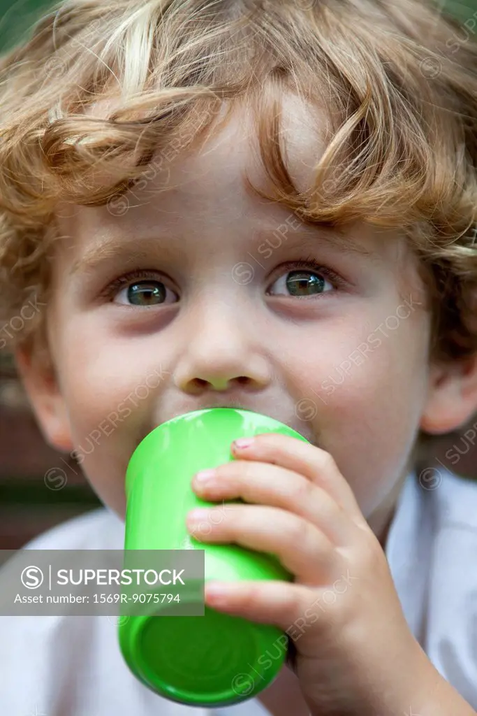 Little boy drinking from cup, portrait