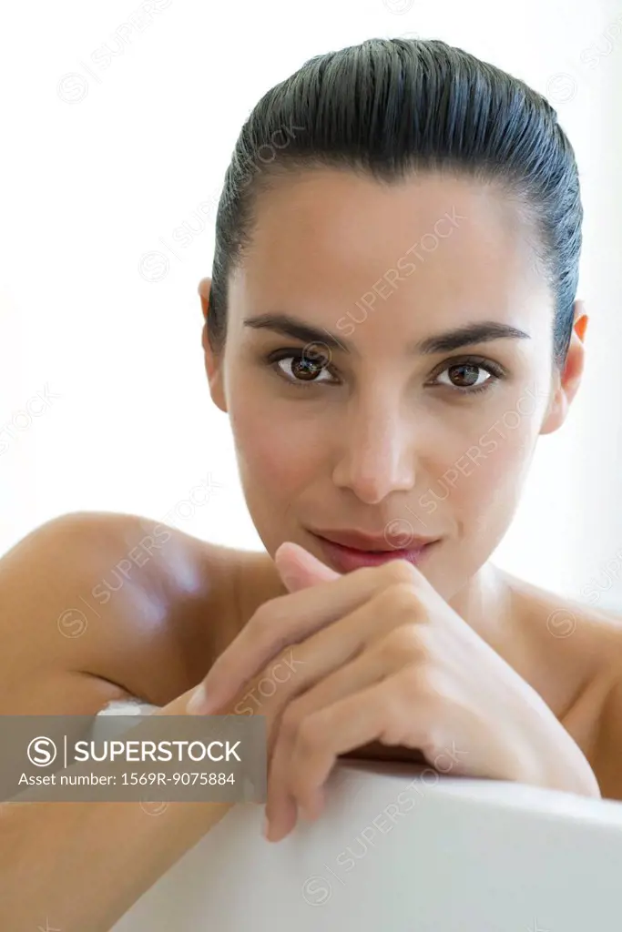 Woman in bath, leaning on edge of bathtub