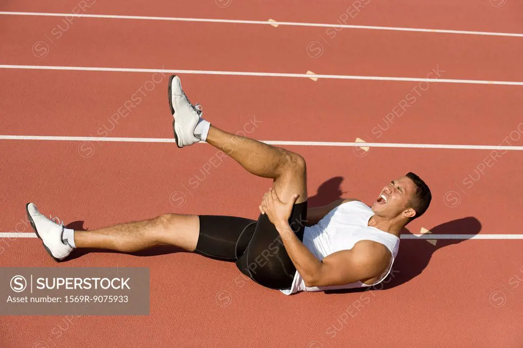 Injured runner lying on running track