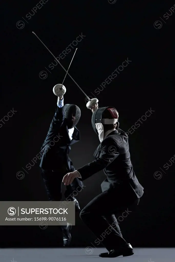 Businessmen fencing