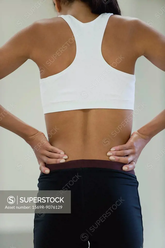 Woman with backache, rear view