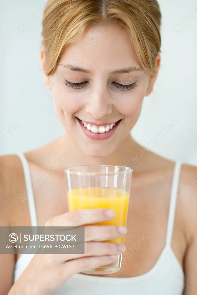 Young woman with glass of orange juice