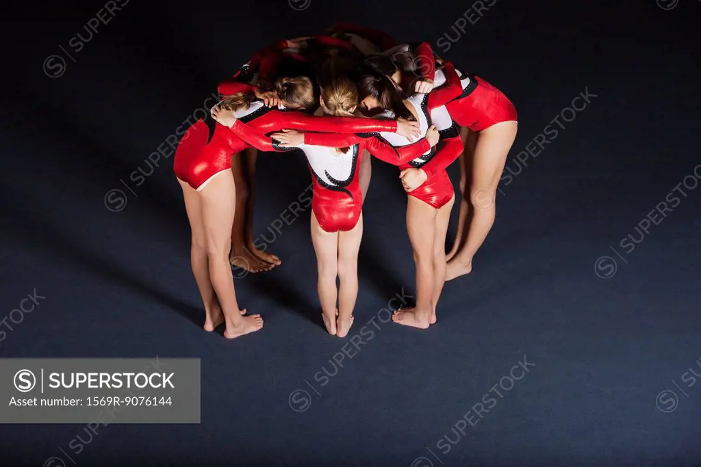 Team of gymnasts huddling