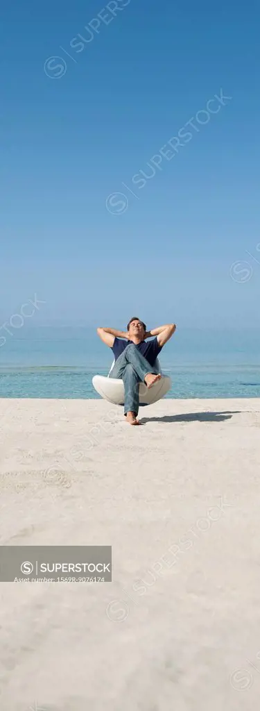 Man relaxing in chair on beach