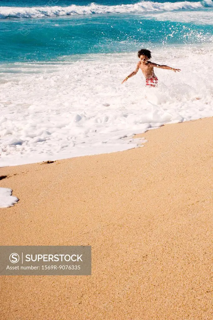 Boy playing in surf at the beach