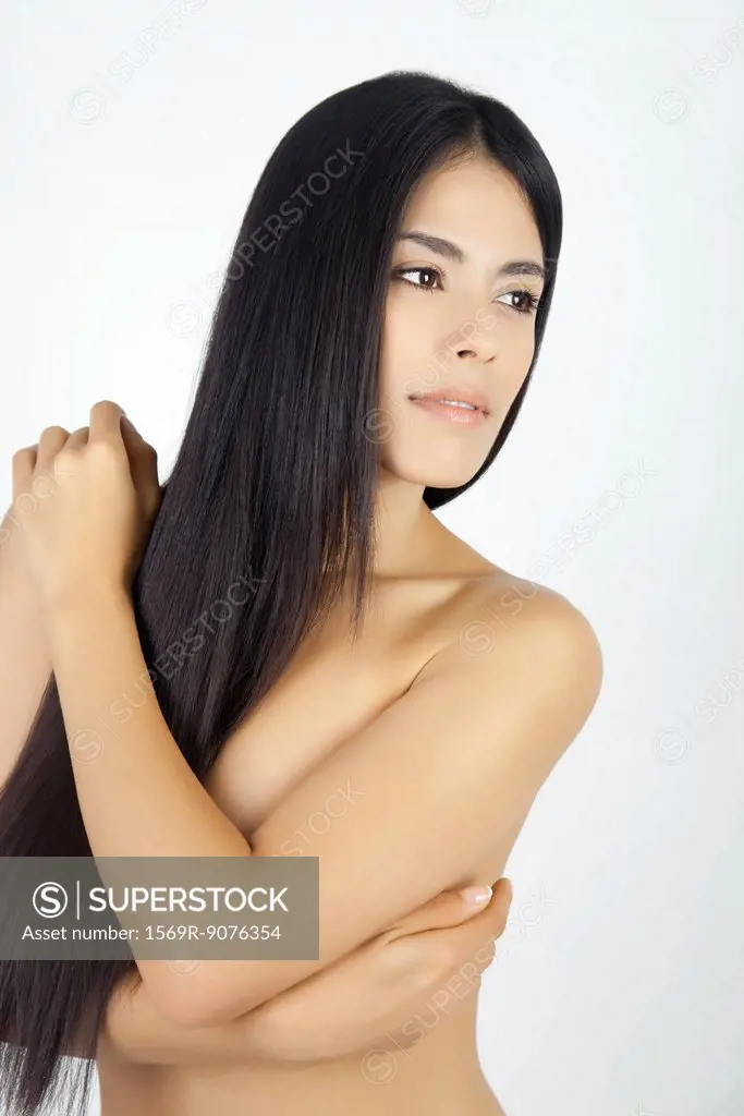 Nude woman with arms folded across chest, portrait