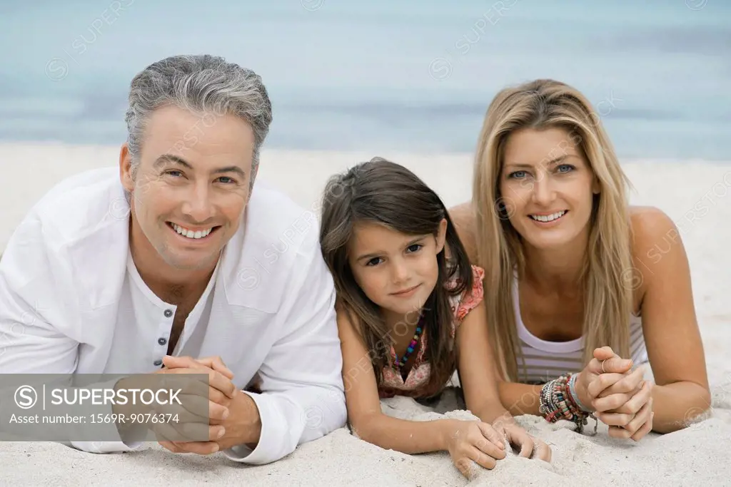 Family lying on beach, portrait