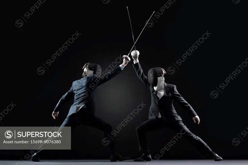 Businessmen fencing