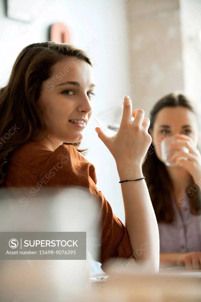 Young women drinking water in restaurant